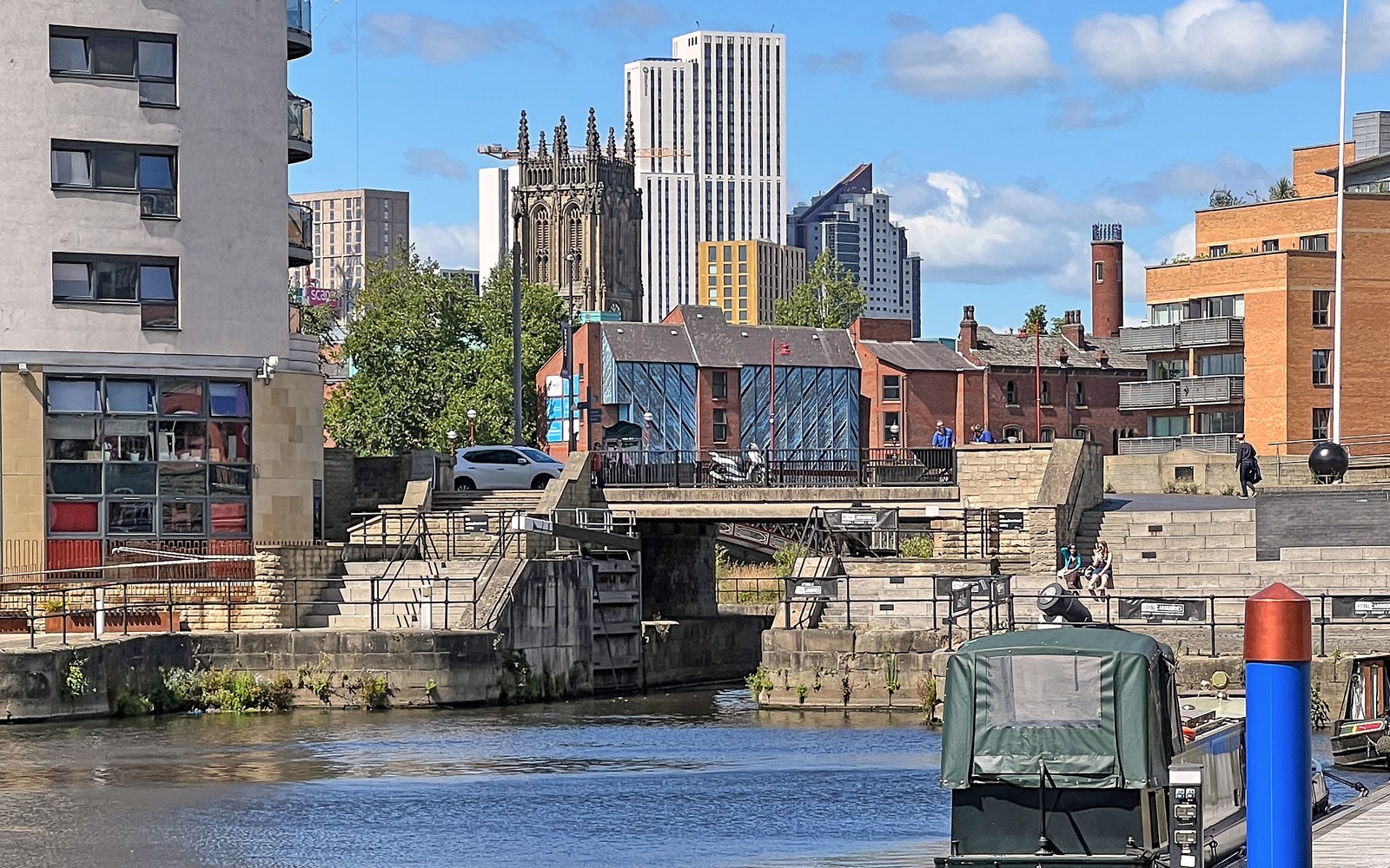 The River Aire waterfront in Leeds with city buildings and moored boats